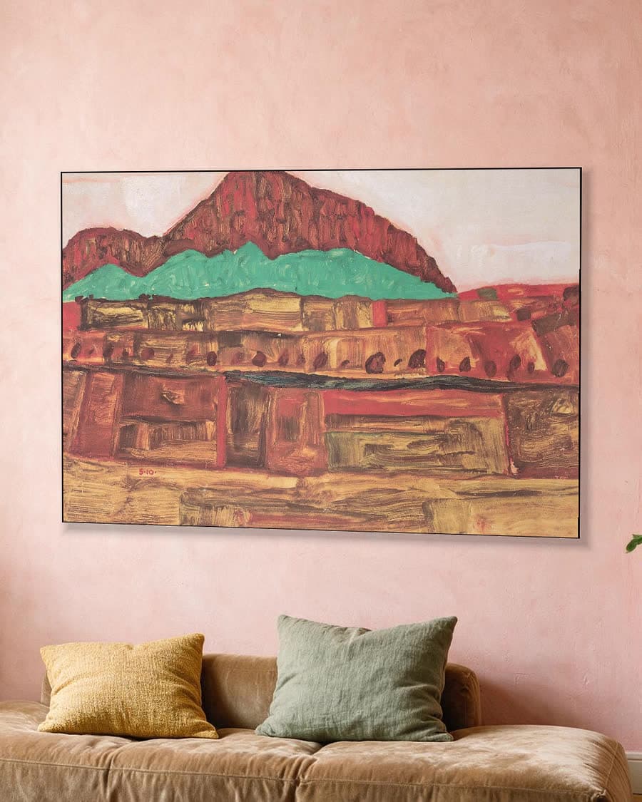 Berglandschap in een aluminium frame aan dezelfde muur